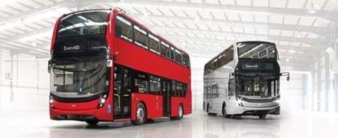 A large red double decker bus turned to the left, and a silver double decker bus, turned to the right.