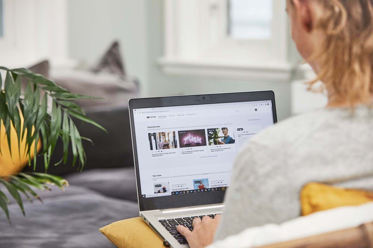 Looking over the shoulder of a person who is using our intranet solution on their laptop.