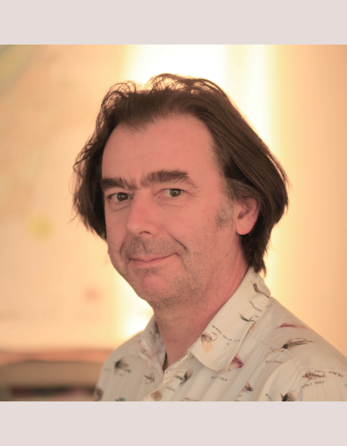 Headshot of Camp Digital speaker Julian Tate. Julian has mid length brown hair and brown eyes