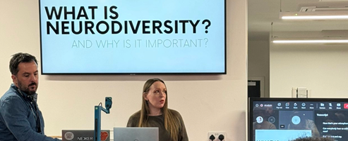 Neurodiversity consultant Rachel Morgan-Trimmer stands in the Nexer Digital office, presenting from a slide titled 'What is neurodiversity?'