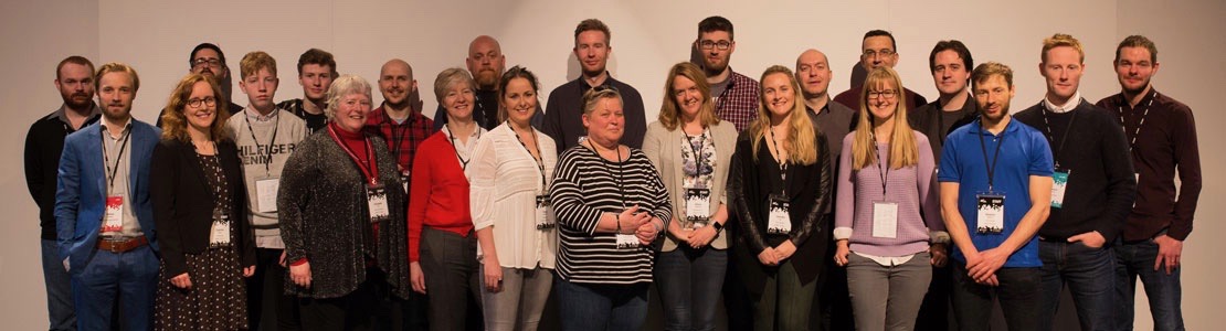 Camp Digital 2018 team photo - a group of white people spread out in a line, smiling. 