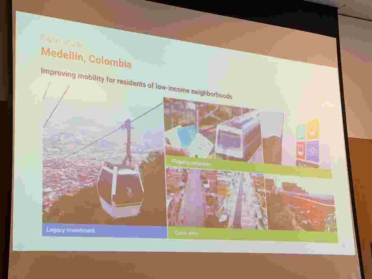 A slide titled 'Case study: Medellin, Columbia. Improving mobility for residents of low-income neighbourhoods. Underneath three images are the words 'Legacy investment', 'Flagship initiatives', 'Quick wins'. 