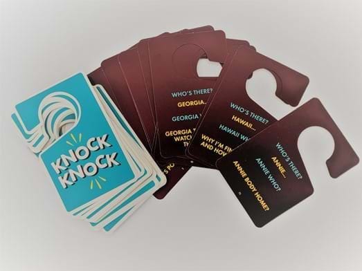A stack of knock knock joke cards, fanned out displaying a few sample jokes.