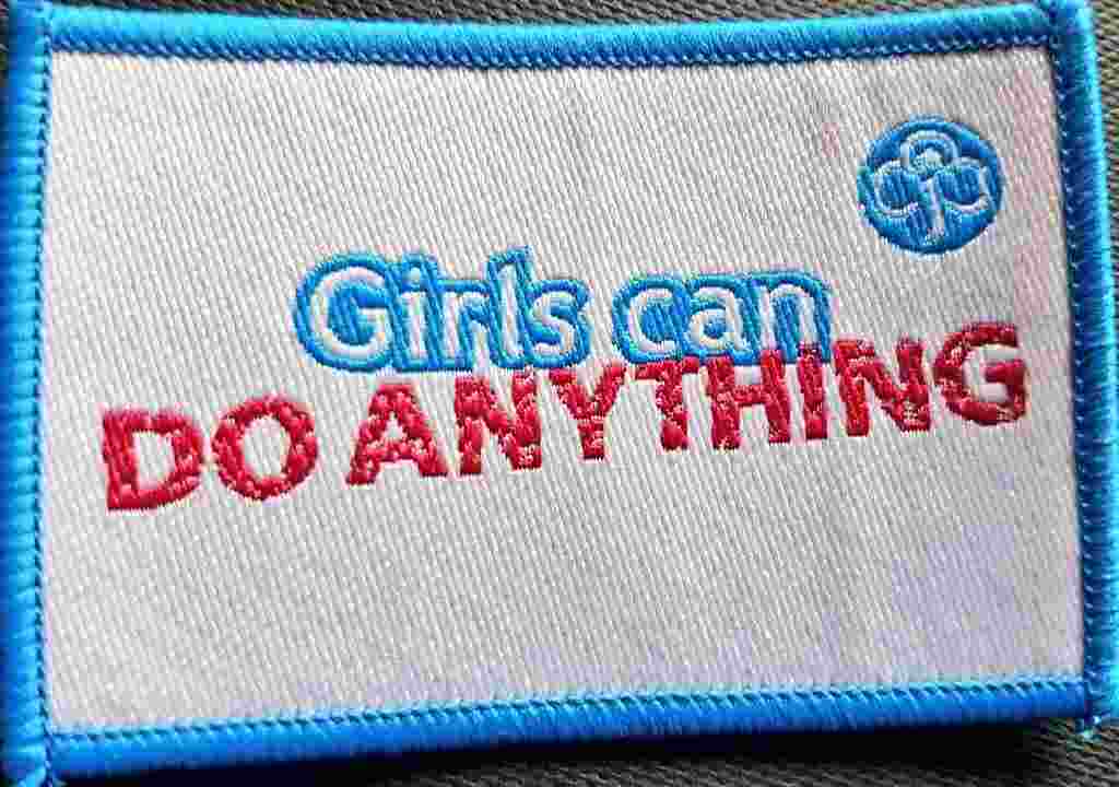 Sew-on Girl Guides badge reading "Girls can DO ANYTHING"
