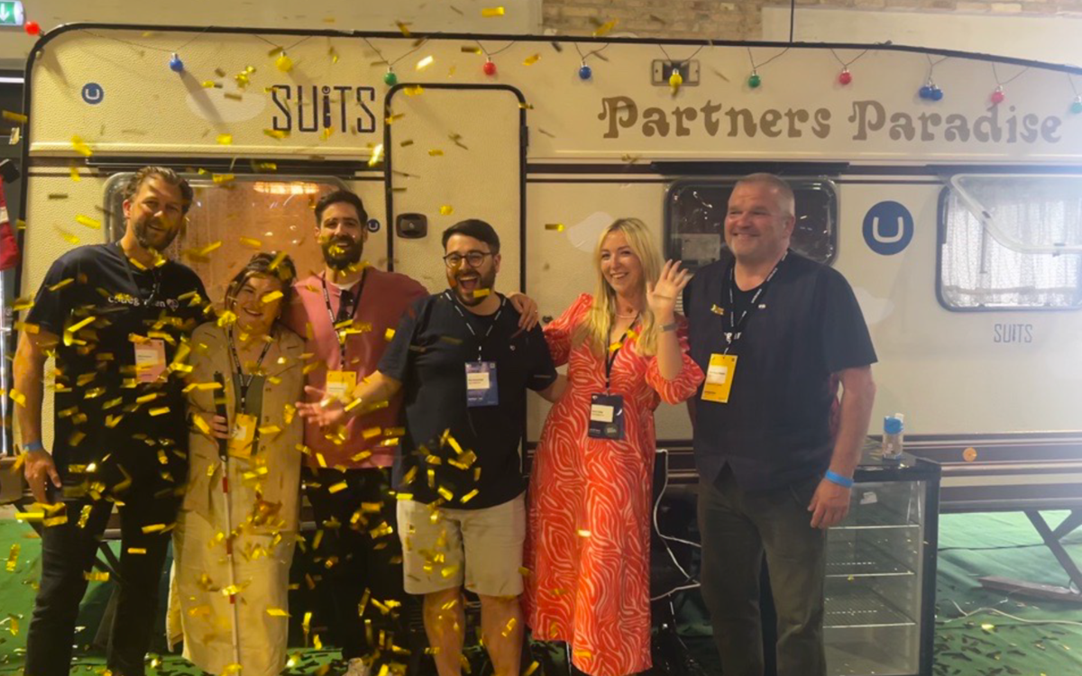 Danny Lancaster, Molly Watt, Amy Czuba, Mike Pedersen and Umbraco CEO Kim Sneum Madsen celebrate Nexer's new platinum partnership outside the partner's paradise caravan.