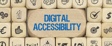 A banner covered in emoji symbols on wooden blocks, with the words Digital Accessibility on a larger wooden block