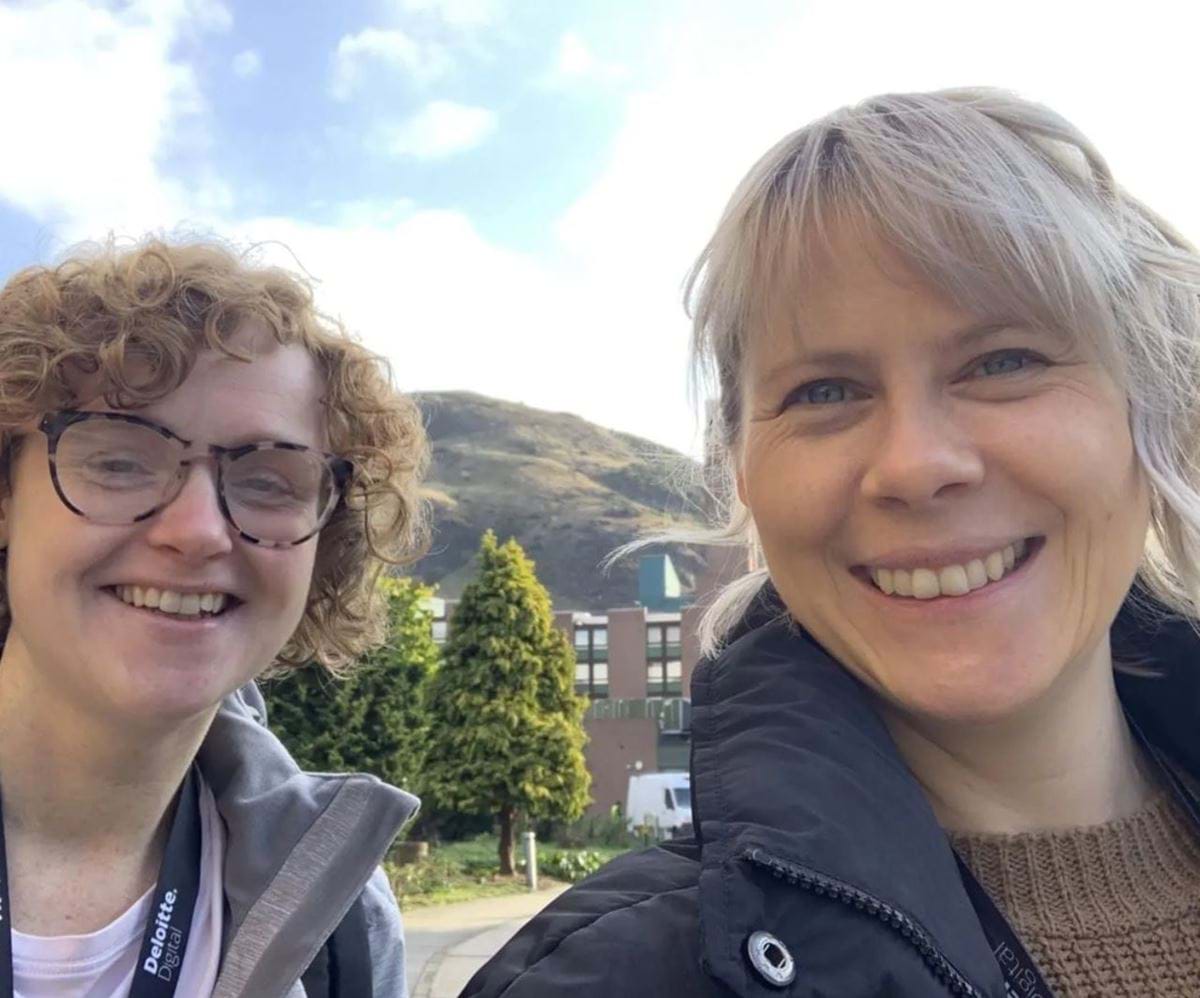 Amy Thornley and Danielle Stone smiling with Arthur's Seat behind them