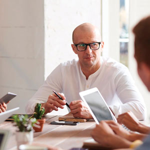 Group of people talking and all holding digital devices