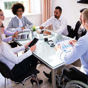 A meeting with digital devices being passed around